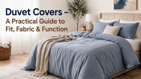 Neatly made bed with blue linen duvet cover in a cozy bedroom